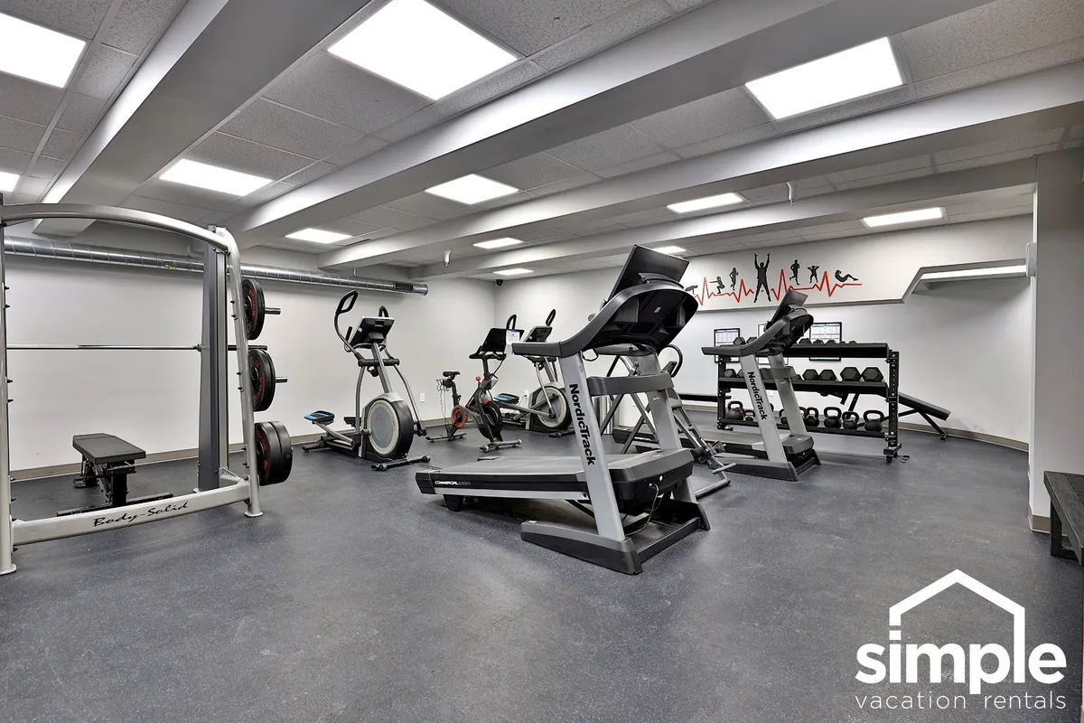 A modern fitness center equipped with weightlifting machines, cardio equipment, exercise mats, and motivational wall art. The space is vibrant and energetic, encouraging guests to pursue fitness goals and participate in group activities.